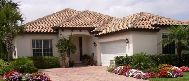 Spring flowers, trees and a bench in the entry set the tone for the exterior. 