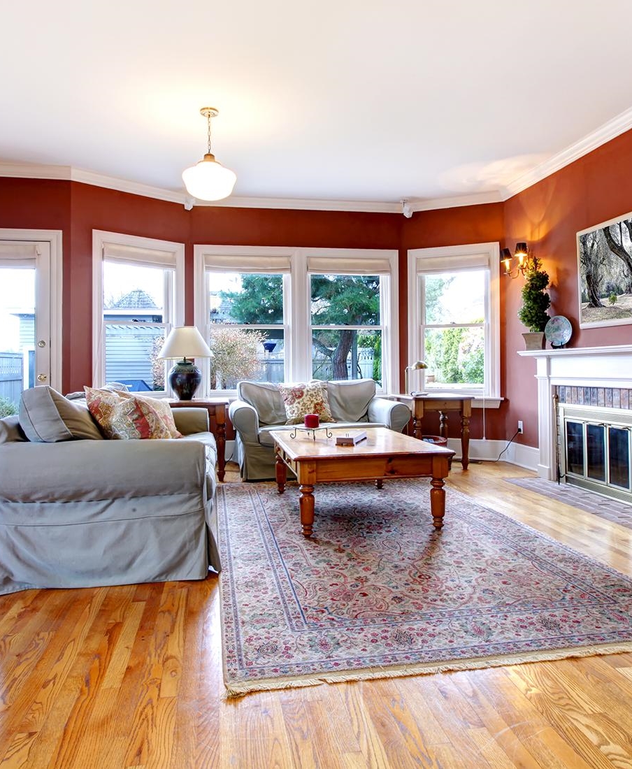 Living Room Contrasts Burnt Sienna Walls with Pale Blue Sofa Slipcovers