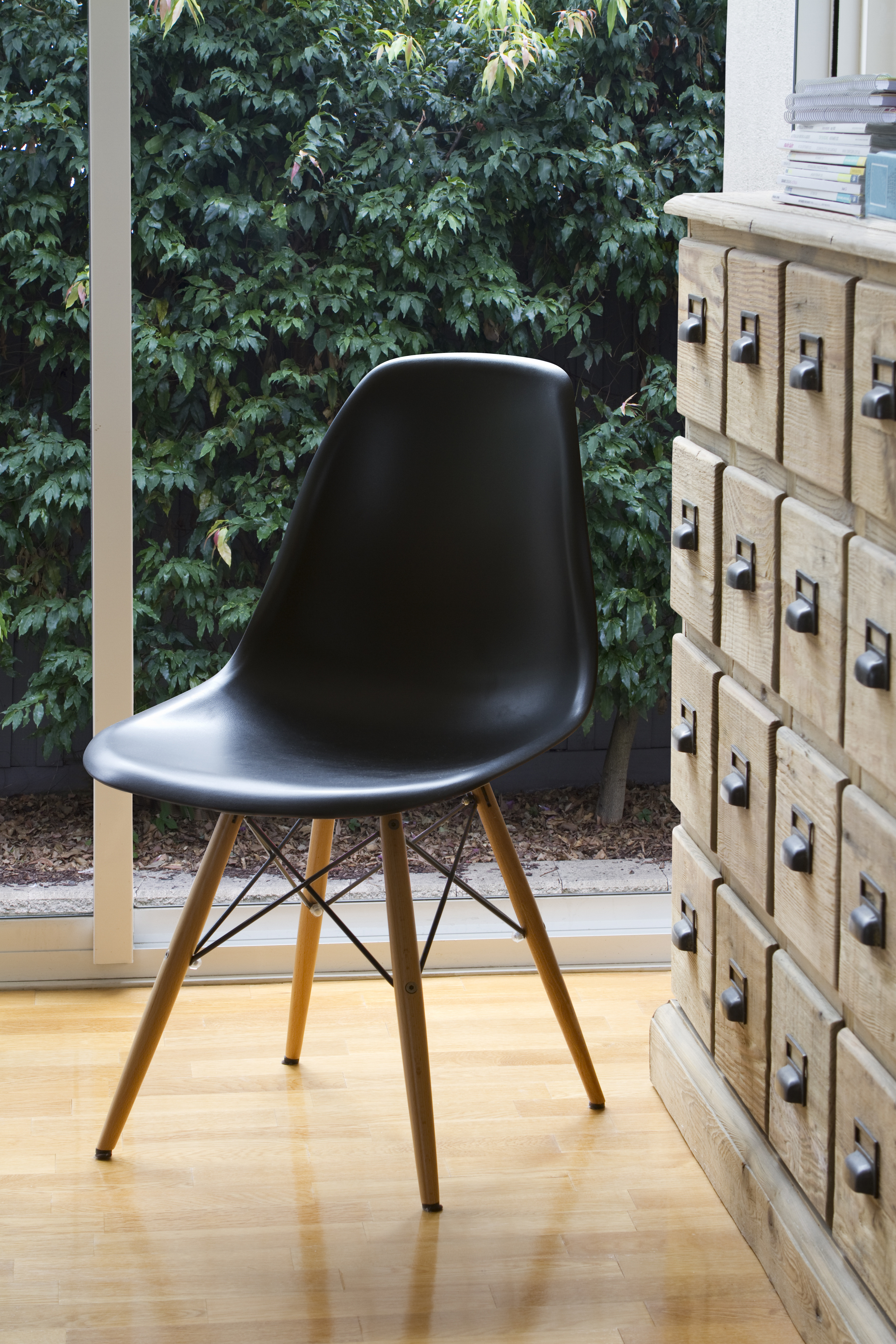 Mid-Century Modern Chair Beside Apothecary Cabinet