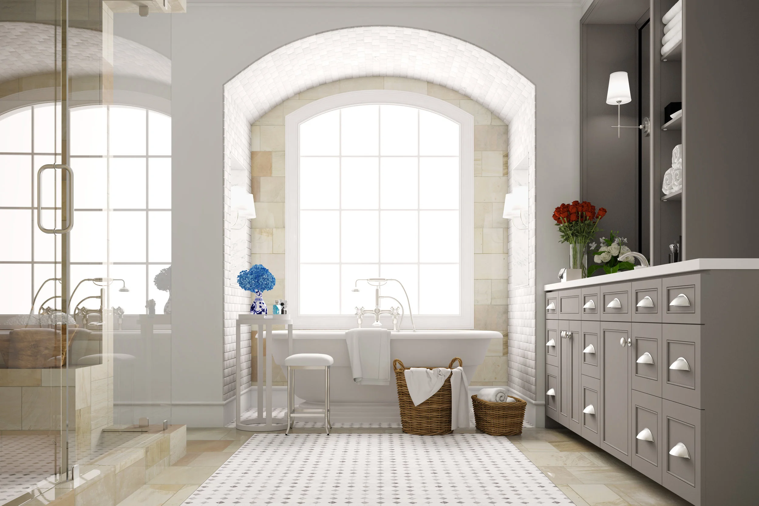 Spacious modern bathroom with huge arched windows, deep white tub, tiled floor, and taupe cabinets. Fluffy towels in baskets.