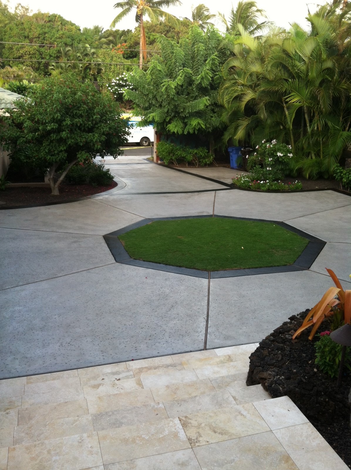 Natural gray concrete driveway with stained border