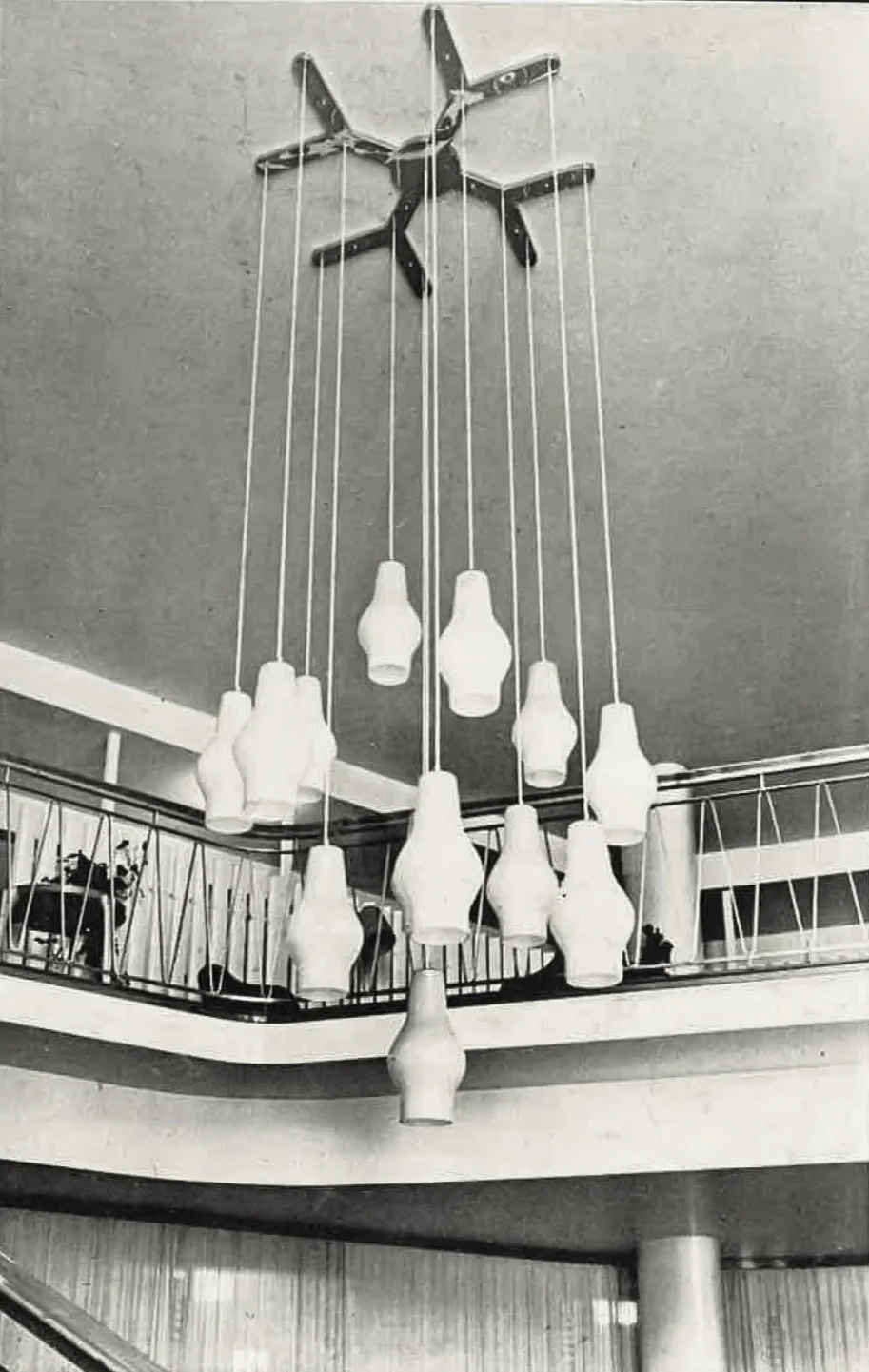Monumental custom-made chandelier with 12 opaline glass shades and a snowflake-formed brass ceiling mount at the Vaakuna Hotel, Helsinki, c.1940s.