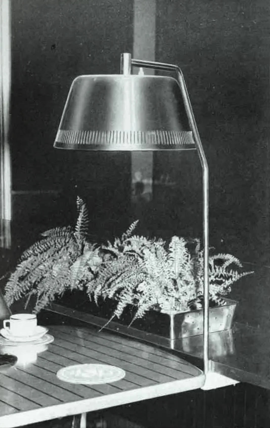 Table mount brass and painted metal lamp at the Elanto Departement Store café, Helsinki, 1954.