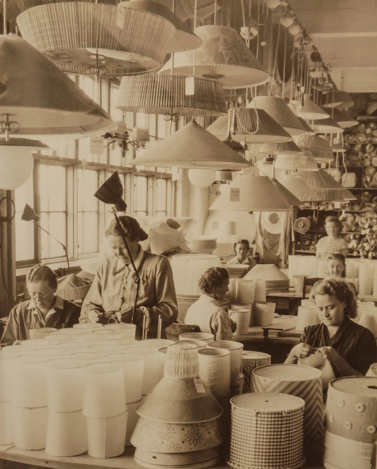 Lampshade department in Oy Taito Ab´s factory in Vilhovuorenkatu, Helsinki, ca.1940s. All lampshades were hand made from various materials, such as silk, linen, cane and wicker. Picture by PT-Arkisto.