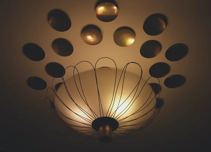 CEILING LAMP WITH SEPARATE BRASS REFLECTORS, ÅBO AKADEMI STUDENT HOUSE, TURKU, FINLAND, 1950-1951. ARCHITECT ERIK BRYGGMAN.