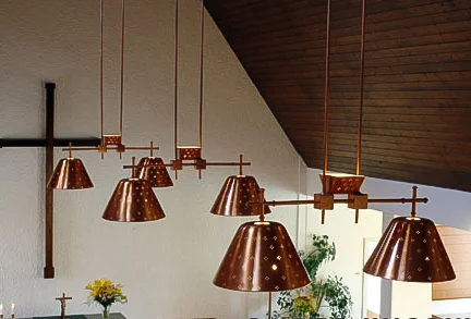 Laune Church, Lahti, Finland, 1953 (completed 1958), architect Erik Lindroos. Perforated ceiling lights in copper by Tynell, which was a relatively unusual material for him to use instead of brass.