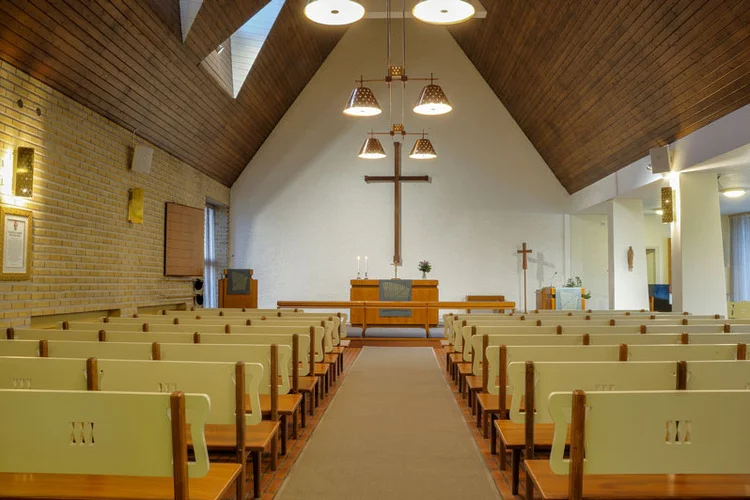 Laune Church, Lahti, Finland, 1953 (completed 1958). Architect Erik Lindroos. Brass perforated wall sconces and perforated twin ceiling lights in copper by Paavo Tynell.
