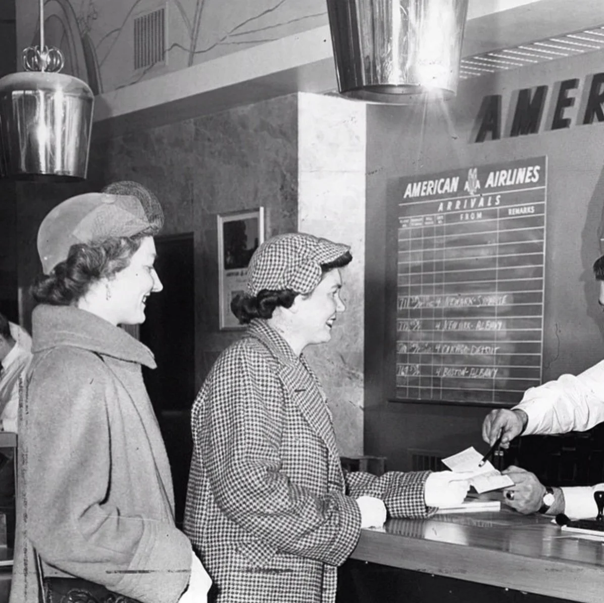 American Airlines counter at the Rochester Airport, NY, c.1950. Perforated brass ceiling lights by Paavo Tynell, model no.FH 252. Image copyright by Democrat and Chronicle archives.