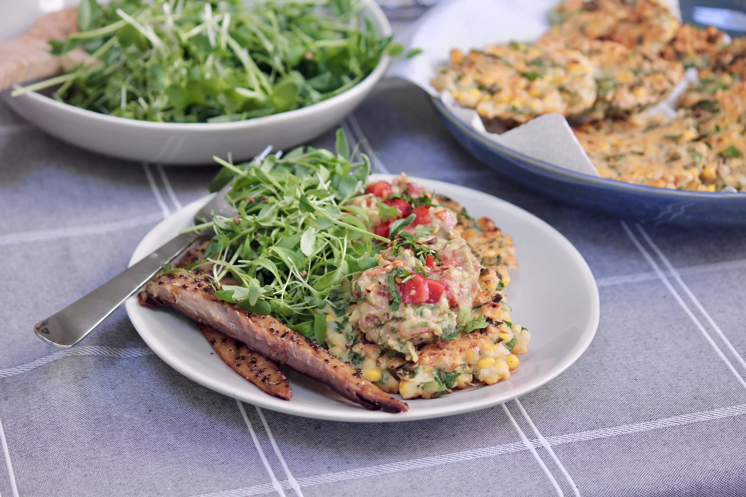 Sweetcorn Fritters with Tomato and Avocado Mash served with Hot Mackerel Fillets and Microgreens
