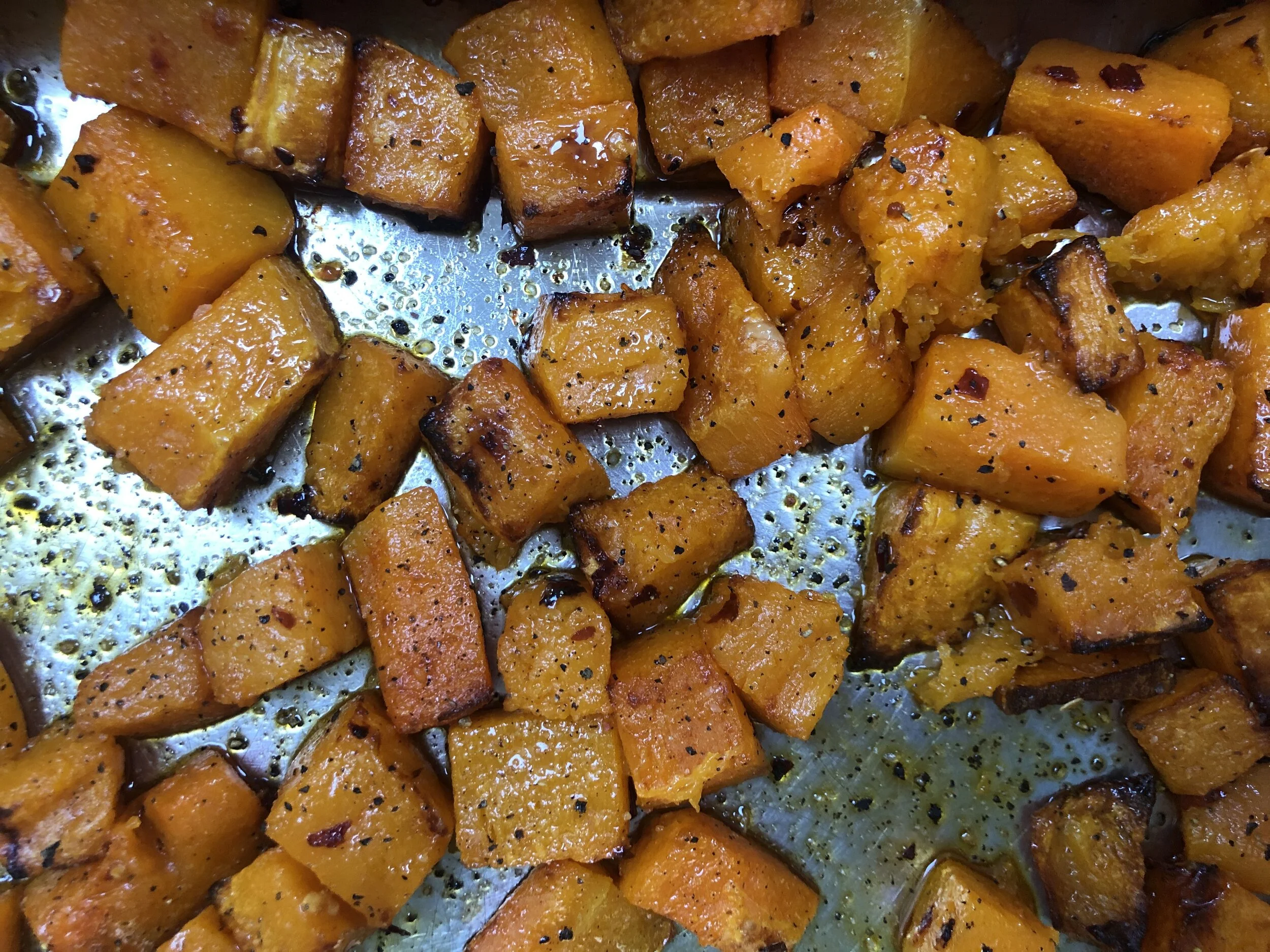 If you leave some space in the tin when roasting squash it helps them to cook more evenly. They are done when soft and slightly caramelised around the edges. Delicious!