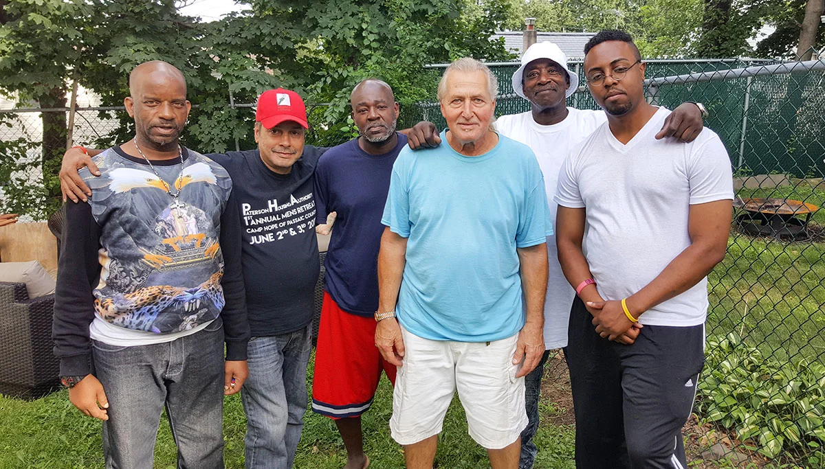 RESIDENTS OF PLACE OF PROMISE ENJOYING SOME FRESH AIR IN THEIR NEW BACKYARD