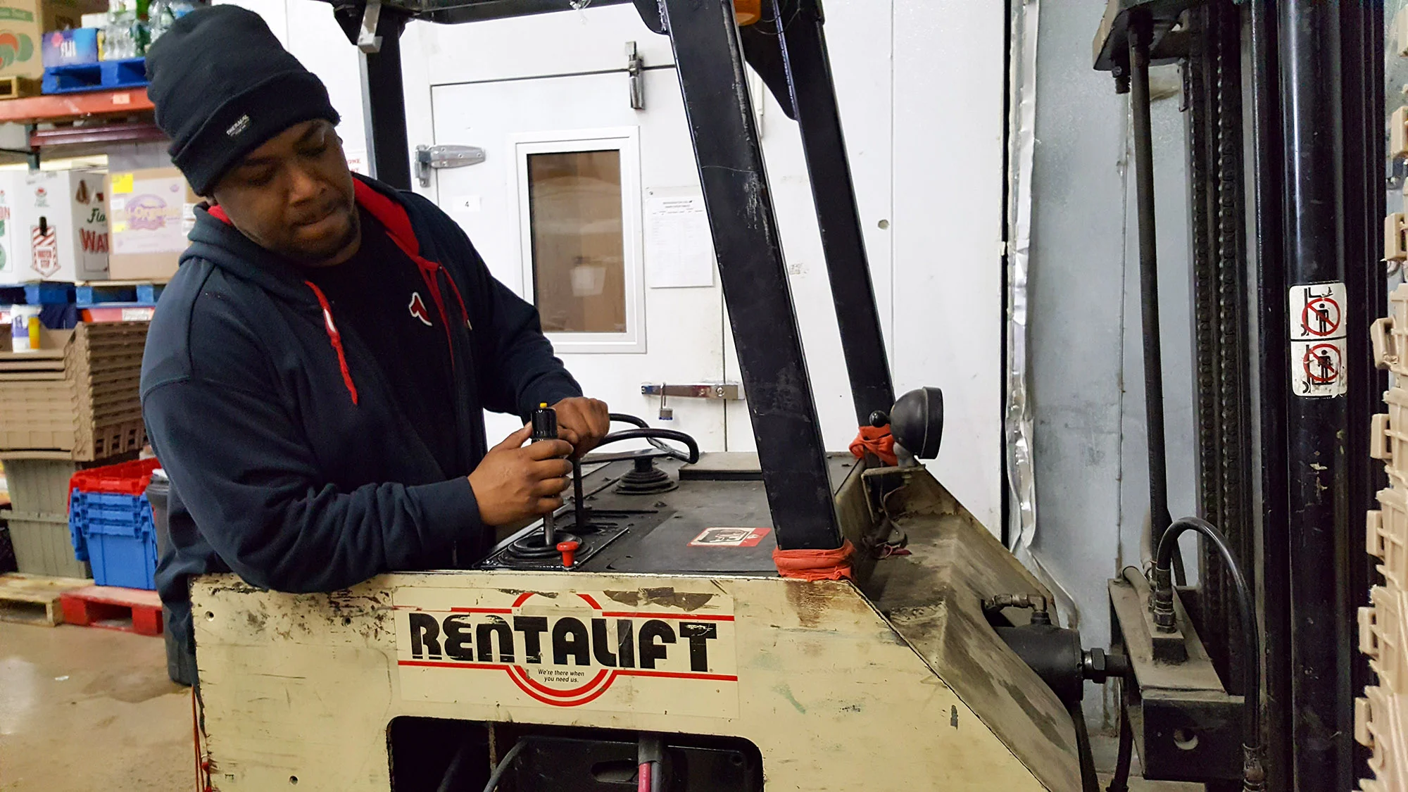 Anthony assisting in CUMAC’s warehouse after his forklift training and certification