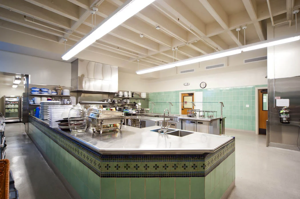 New kitchen at Hilltop High School incorporates an original tile wall from the therapy pool.