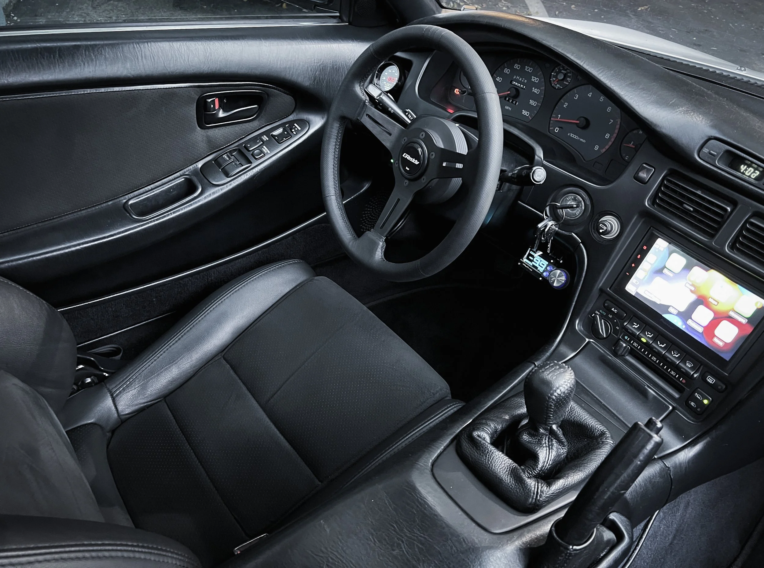    I also sourced a  JDM electronic gauge cluster  to complement the E153 manual transmission and its electronic speed sensor.  While updating the cluster, I redesigned the speedometer dials and integrated a  45mm Omori boost gauge into the factory b