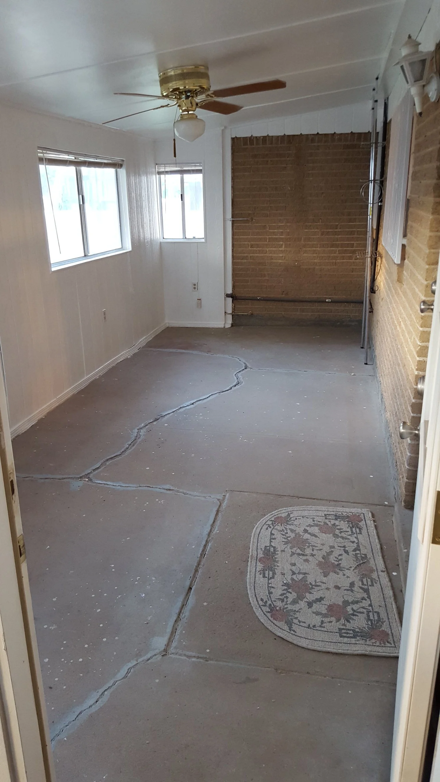 Back enclosed patio with ceiling fan and electrical outlets