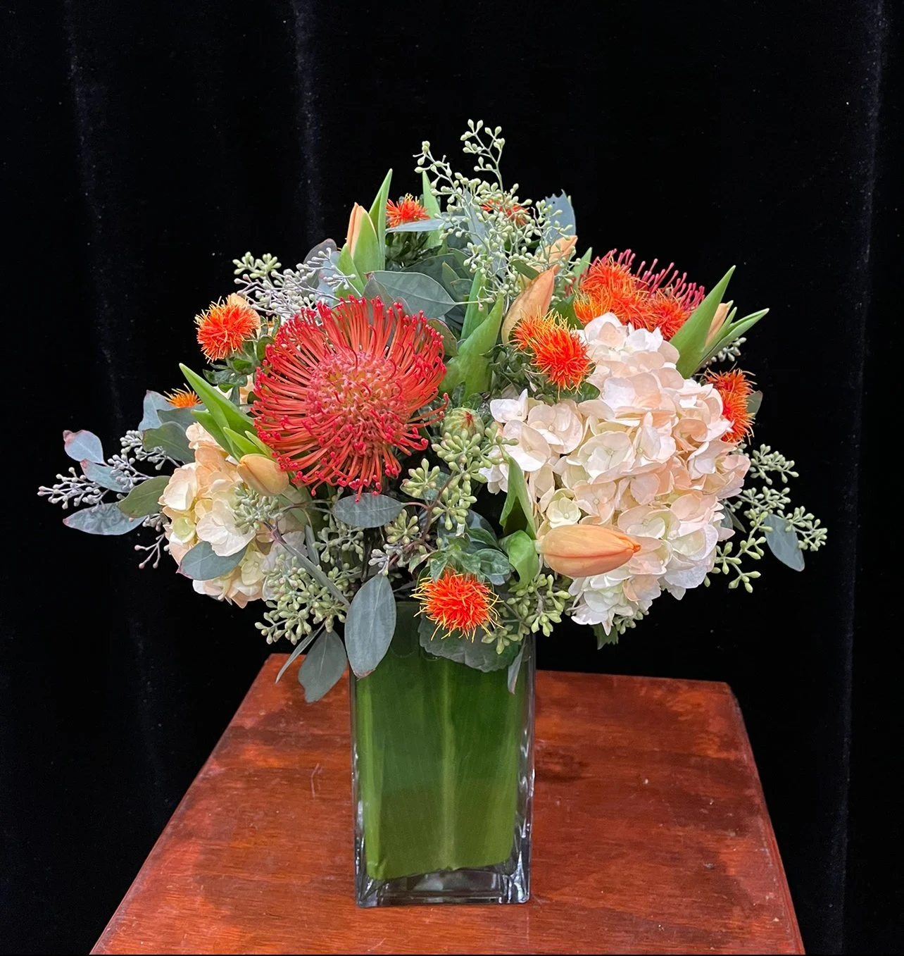 online-Red Pincushions, Orange Safflowers, Orange Tulips, Dyed Peach Hydrangeas & Seeded Eucalyptus.jpeg