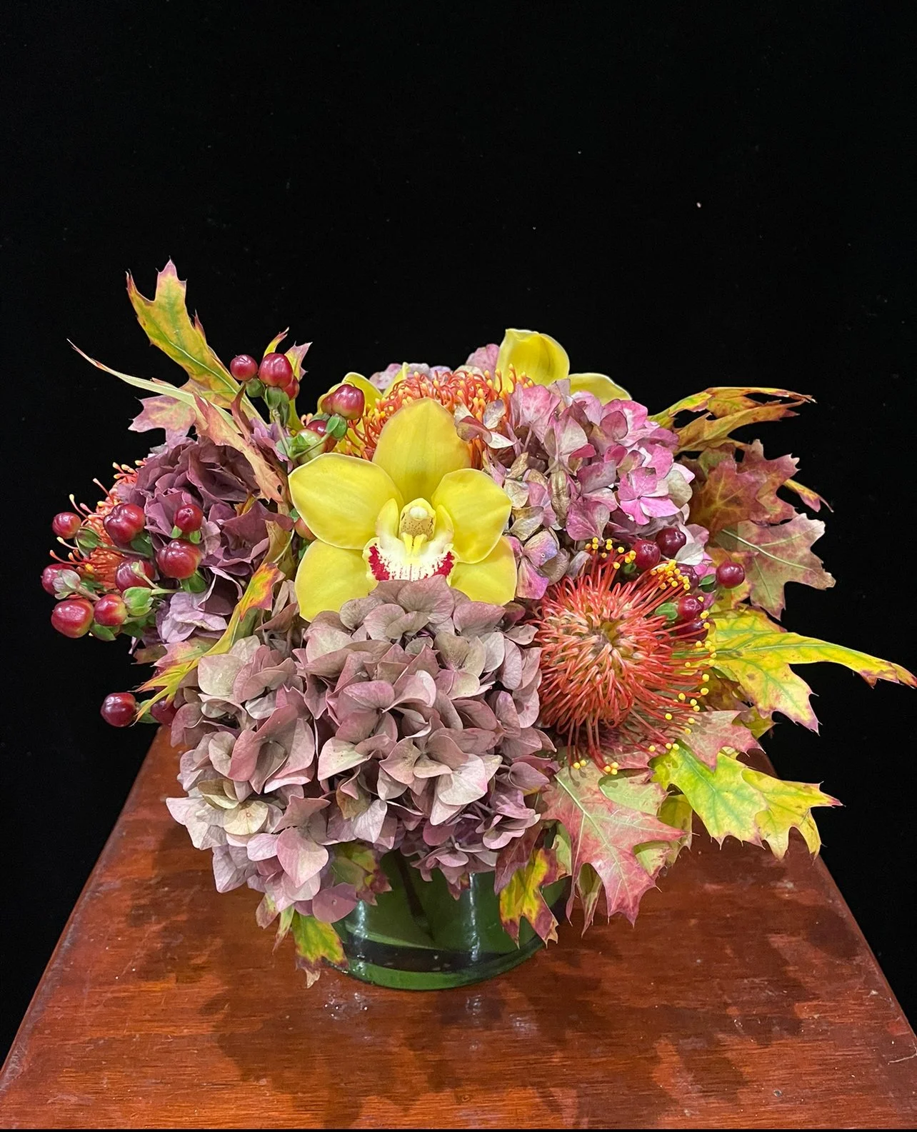 rustic-hyrangeas-pincushion-cymbidium-orchids-hypericum-berries-oak.jpeg