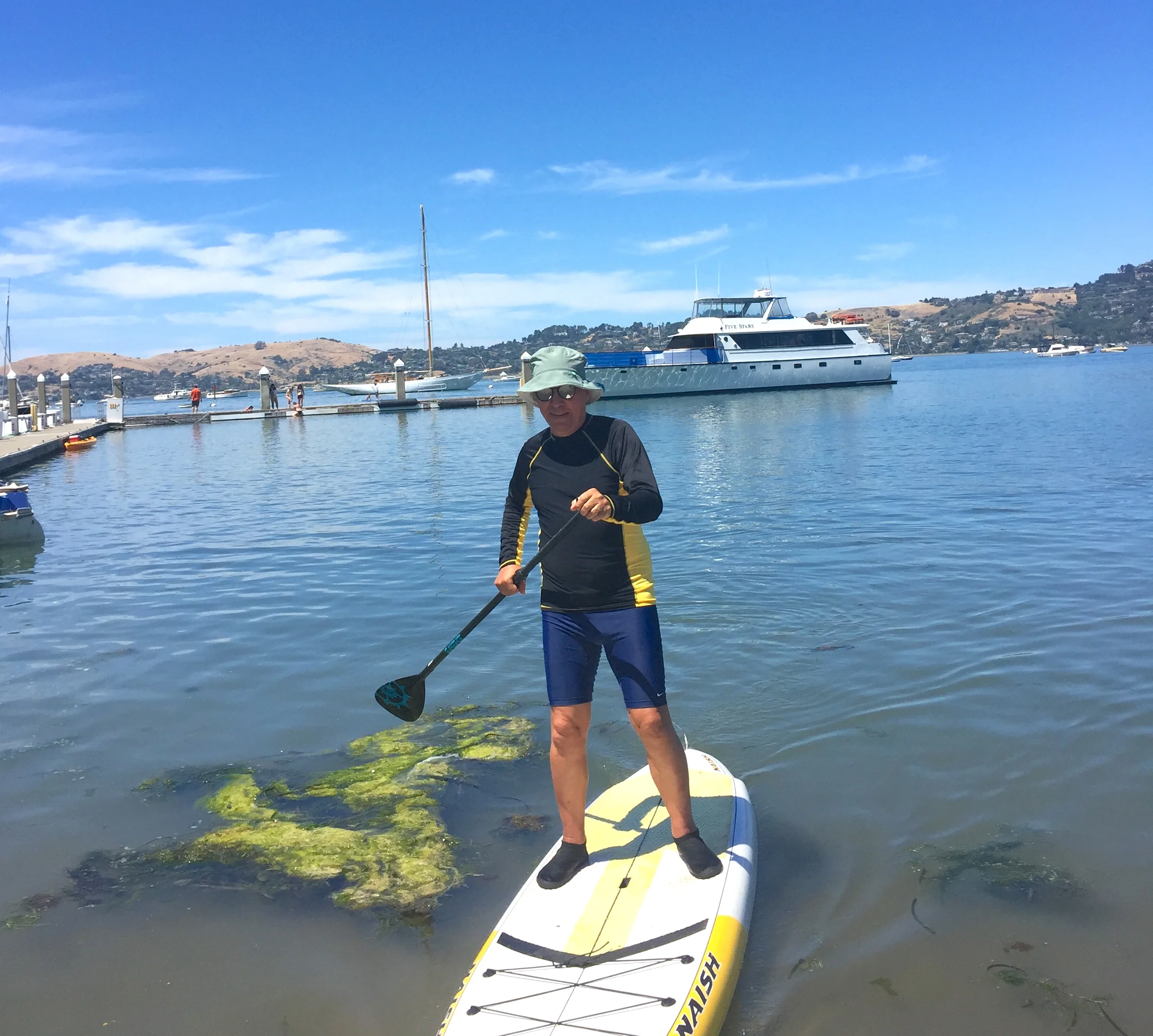 Co-Host Gregg McVicar comes in for a beach landing while paddle boarding with friends. Photo: Gabriela Castelán.