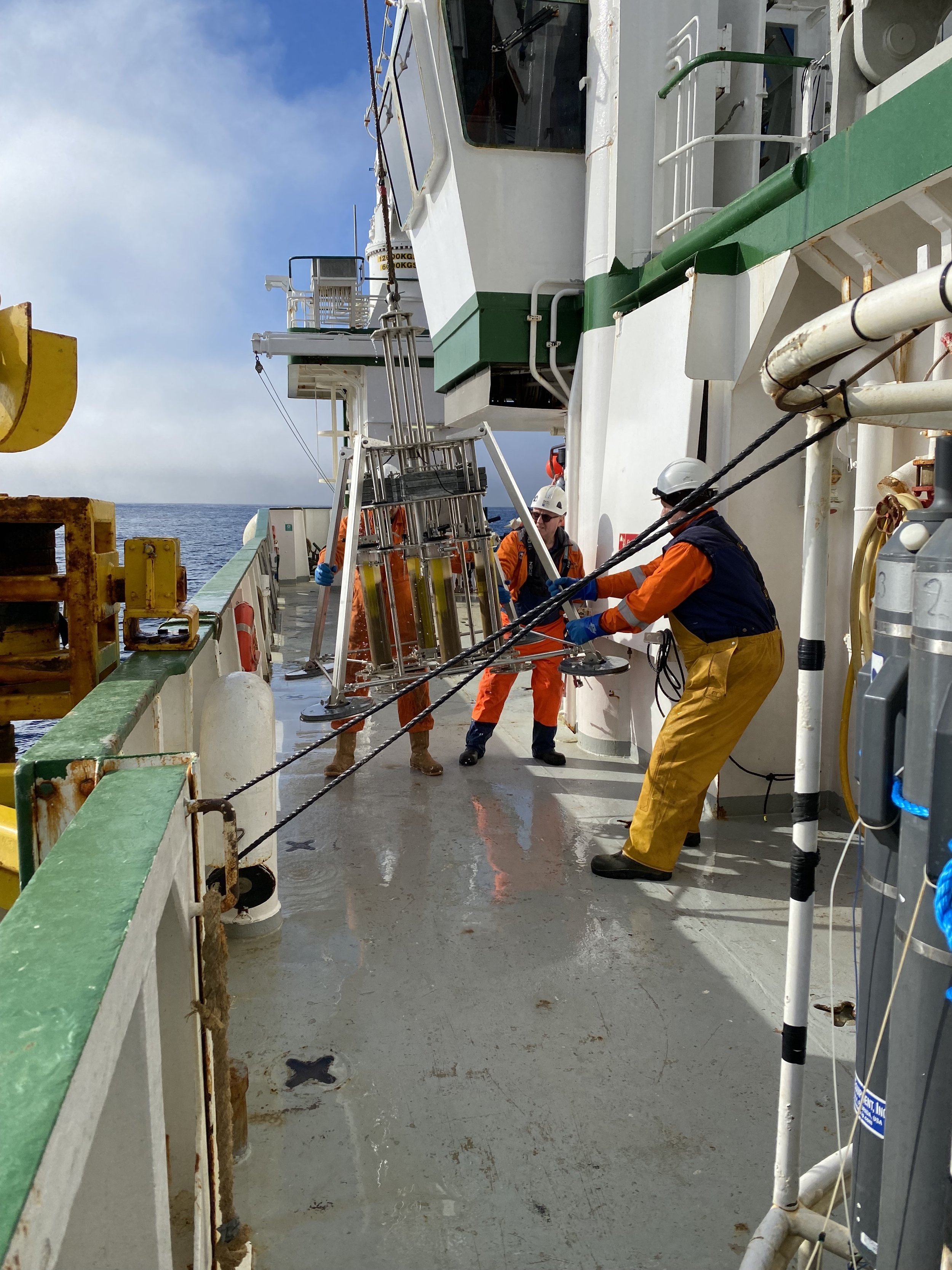    Crew members settling the multicorer on deck.   