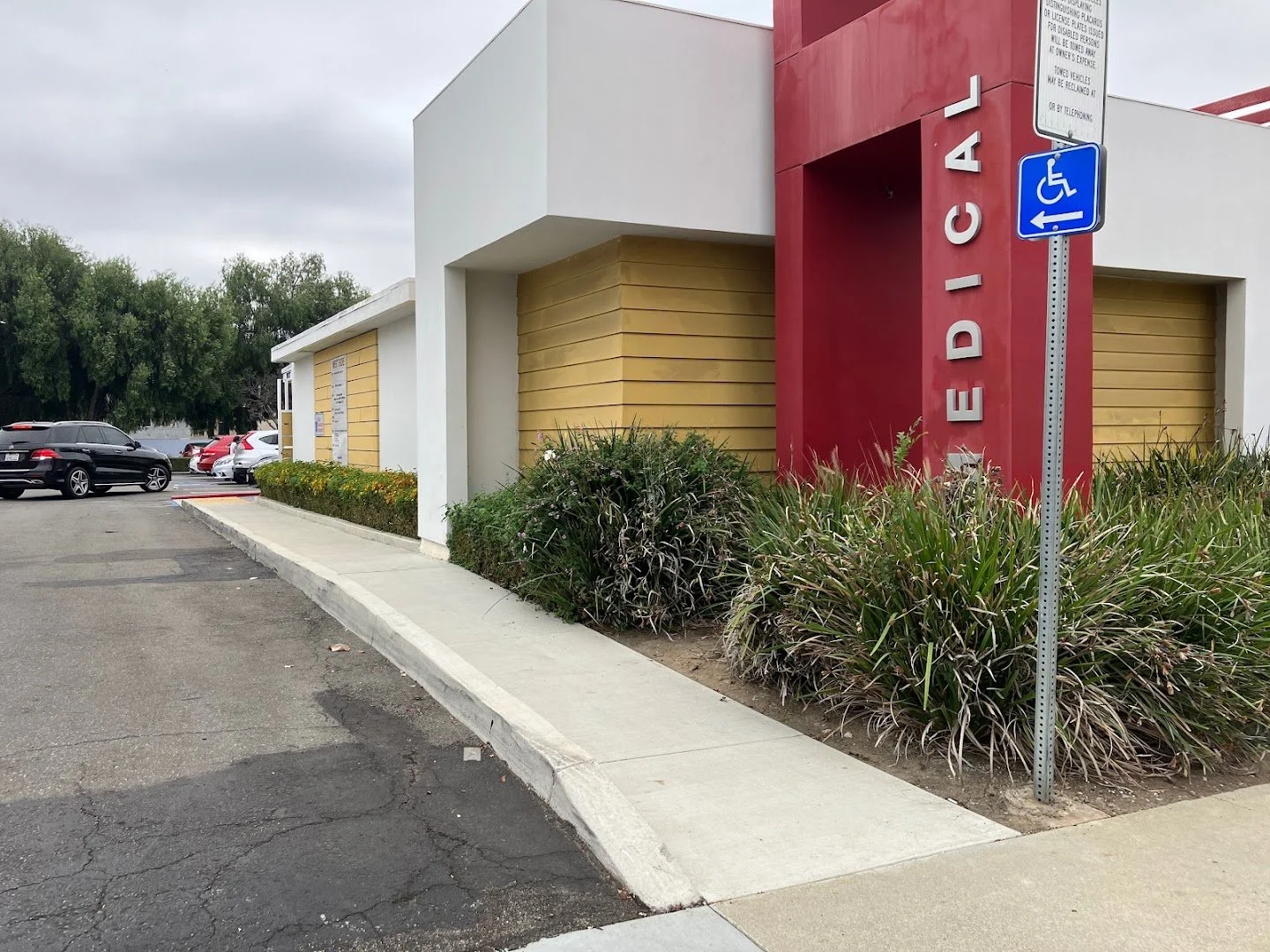 Accessible parking signage at the Medical Plaza entrance, directing patients toward the Amicus Arthritis & Osteoporosis Center building