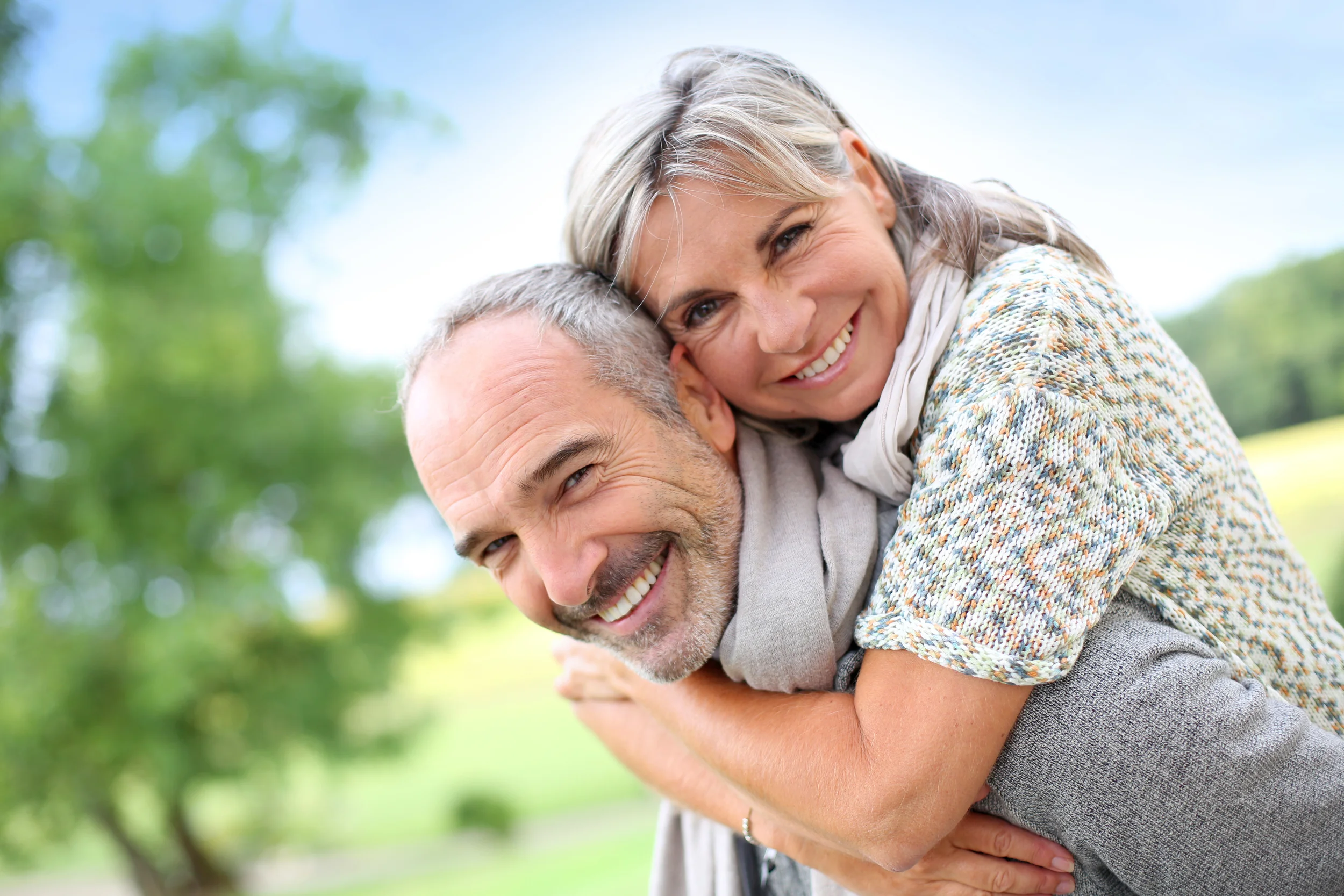 Smiling older couple embracing outdoors