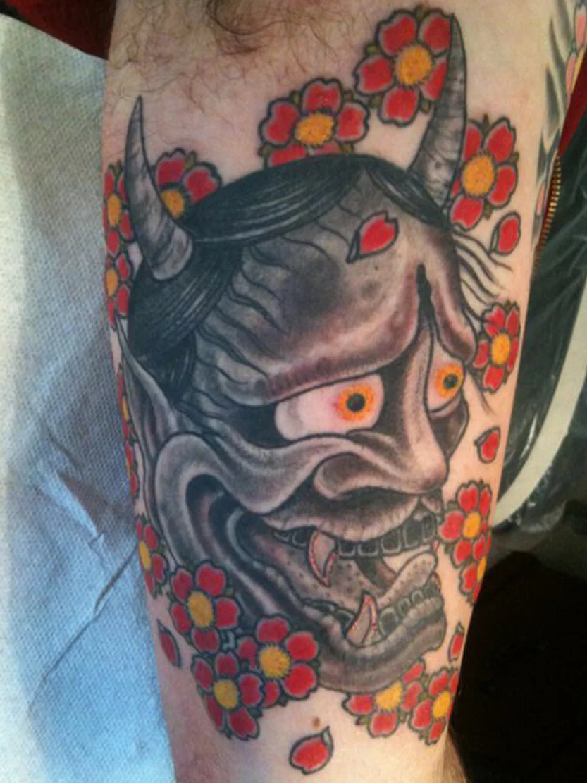 Hanya mask tattoo on musician Rodney Wirtz — inside bicep placement by Los Angeles tattoo artist Jeffery Page at Get Away Tattoo