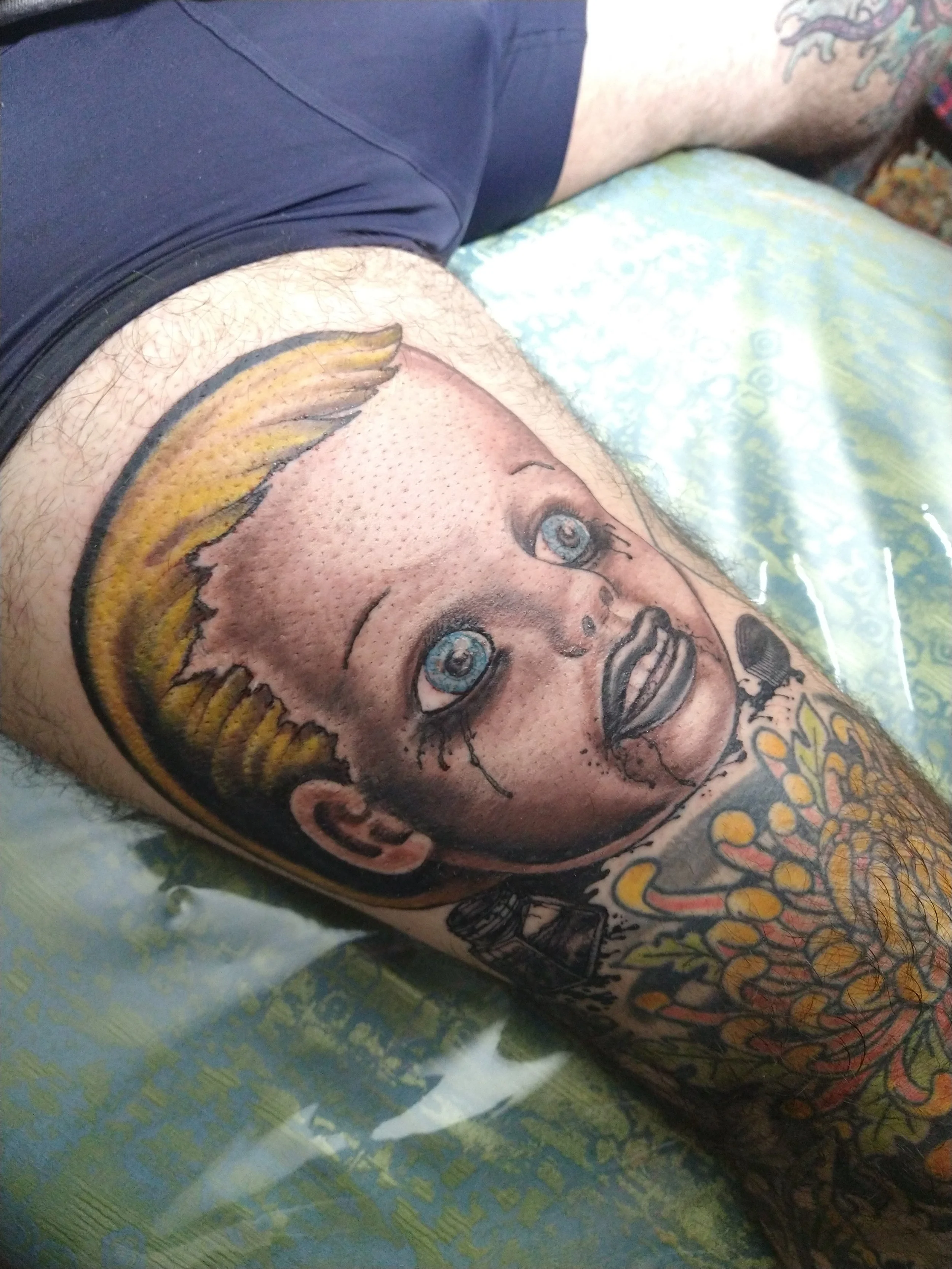 Freehand Grying black Ink Dollhead tattooed on Victor the Chef by Los Angeles Tattooer Jeffery Page at Get Away Tattoo