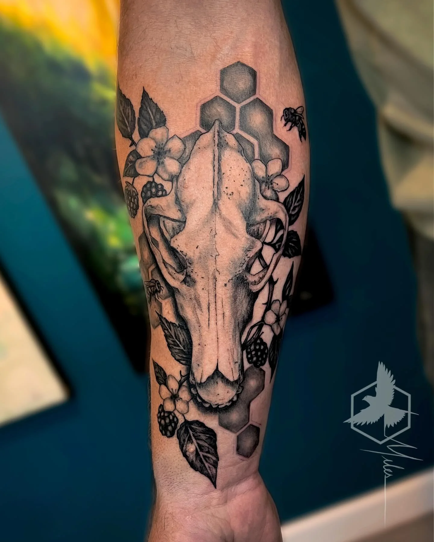 A wolf skull with blackberries, hexagons, and bees