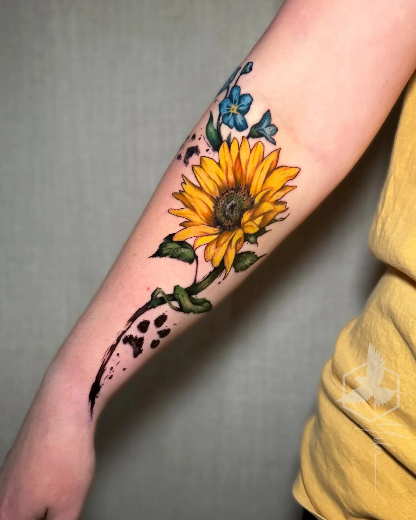 A meaningful memorial tattoo for a client&rsquo;s dogs, combining flowers and their paw prints. Thank you for trusting me with such a special piece.