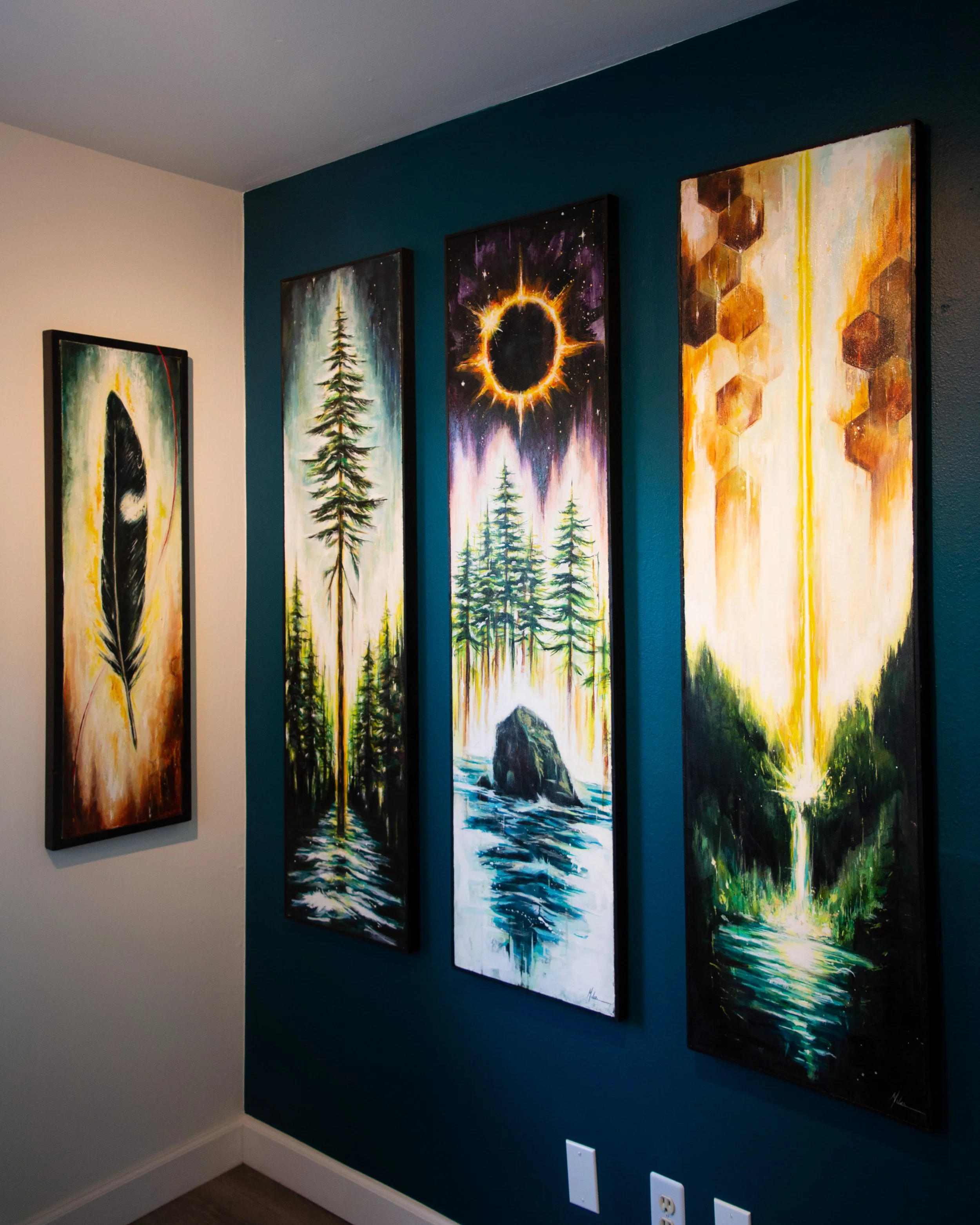 A set of four vertical landscape paintings featuring nature scenes with trees, water, and celestial elements such as a solar eclipse and stars, displayed on a dark teal wall.