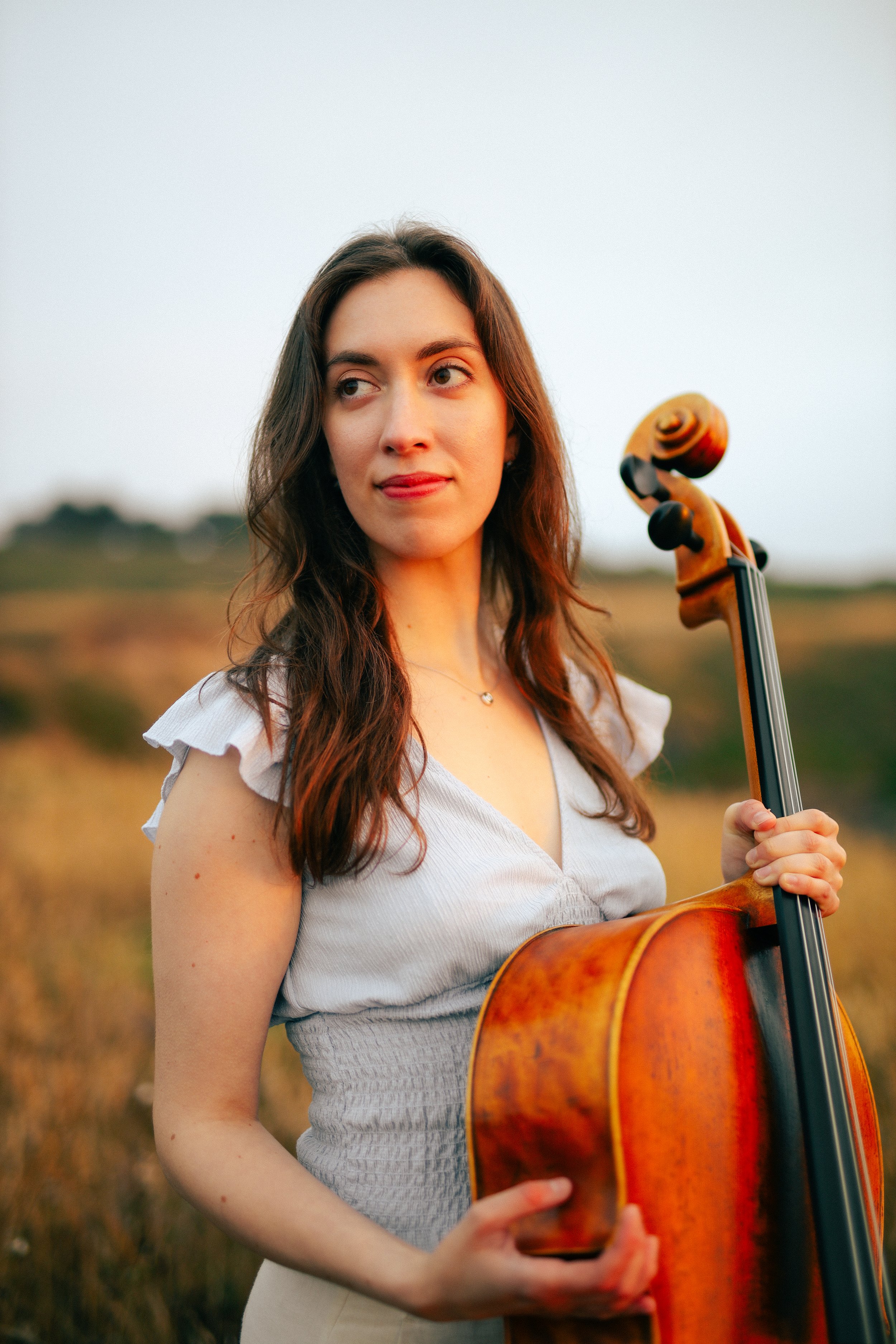 cellist portrait in nature golden hour