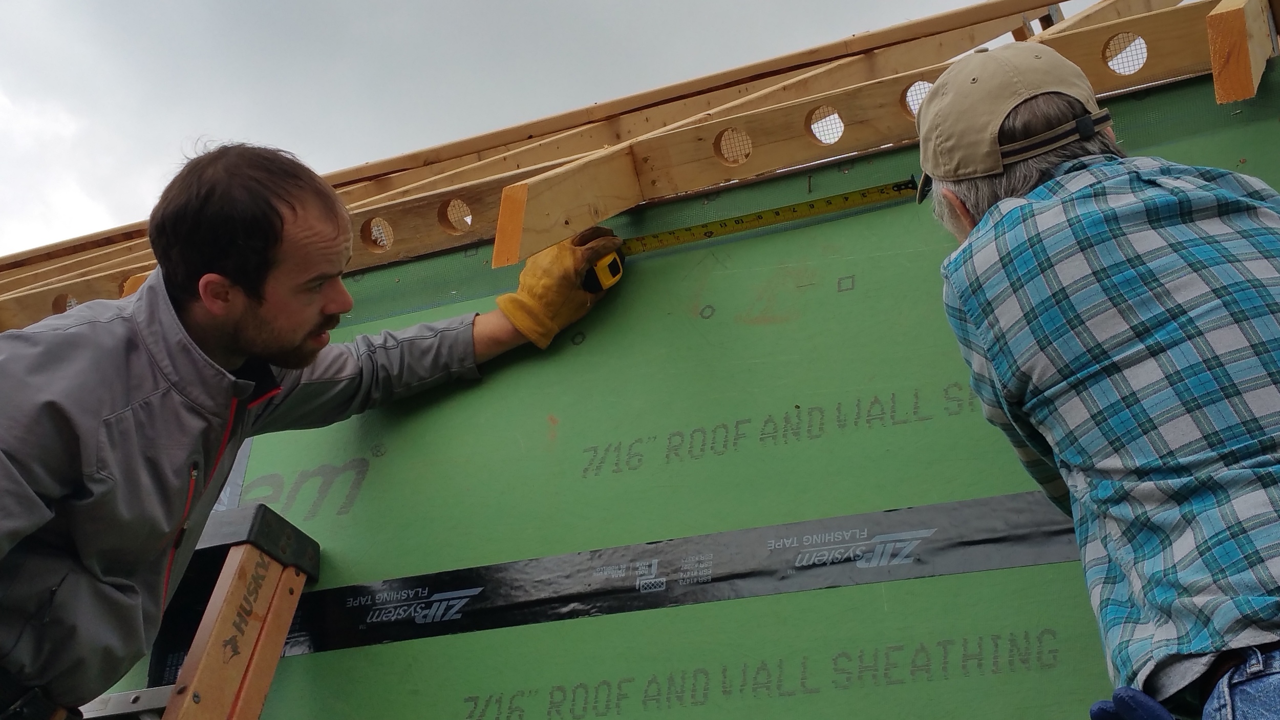 Our Technician Stephen (L) and our photographer Jim Smith (R) installing a bug screen for the upper portion of the rain screen, which was also installed on the bottom of the wall.