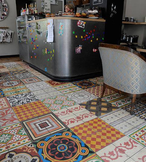 Randomly laid squares of patterned tiles make&nbsp;up a vibrant patchwork floor.