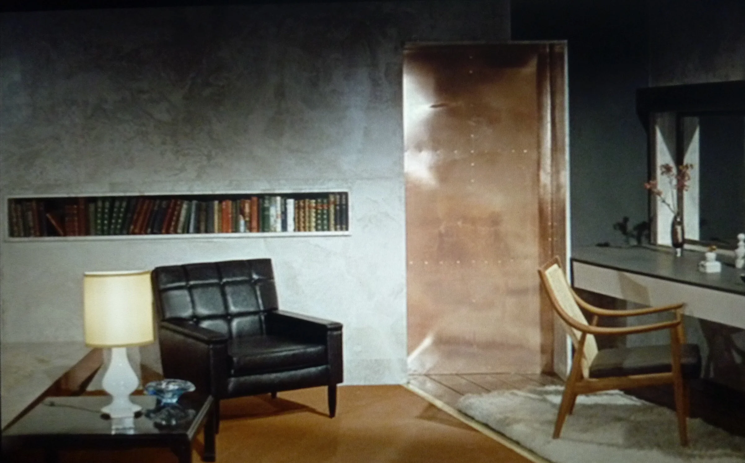 Goldfinger again. We will use the design of the inset shelf; a strong graphic for housing paperback books, (Ike has a huge collection he puts in the rooms). Copper plating like that on the door will be used to clad the shower and freestanding baths.