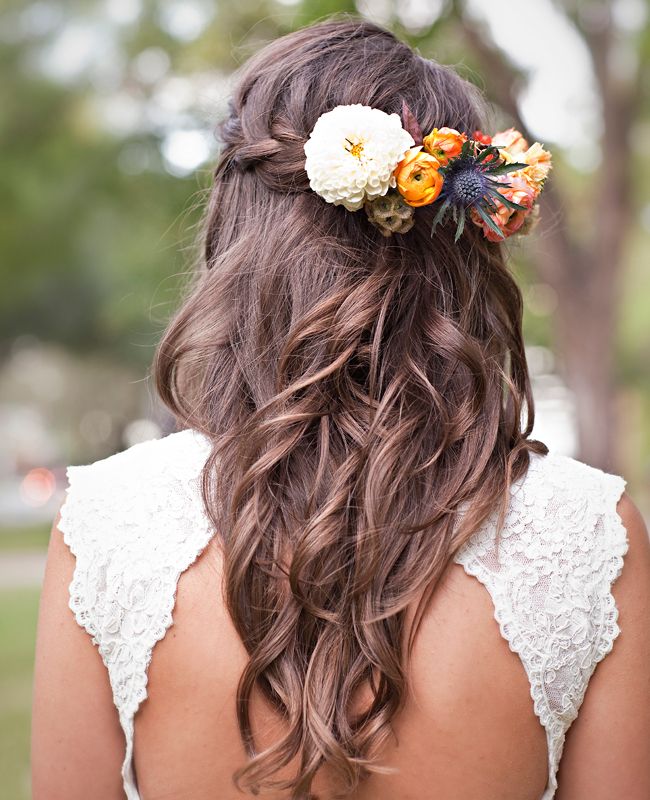 These simple loose curls create this really pretty style, and the flower choices are very suitable for an autumn or spring wedding.