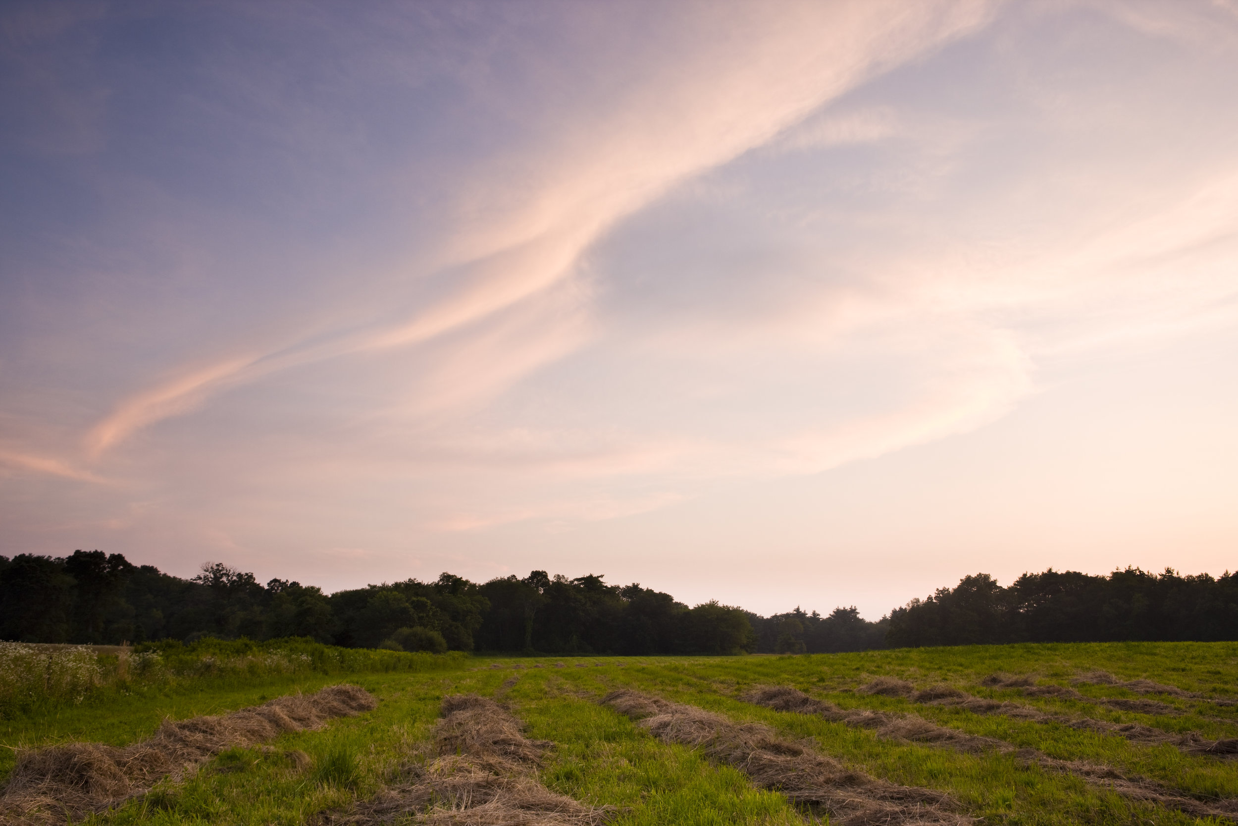 Clouds after sunset over a hay field in Bridgewater, Massachusetts. Summer.
