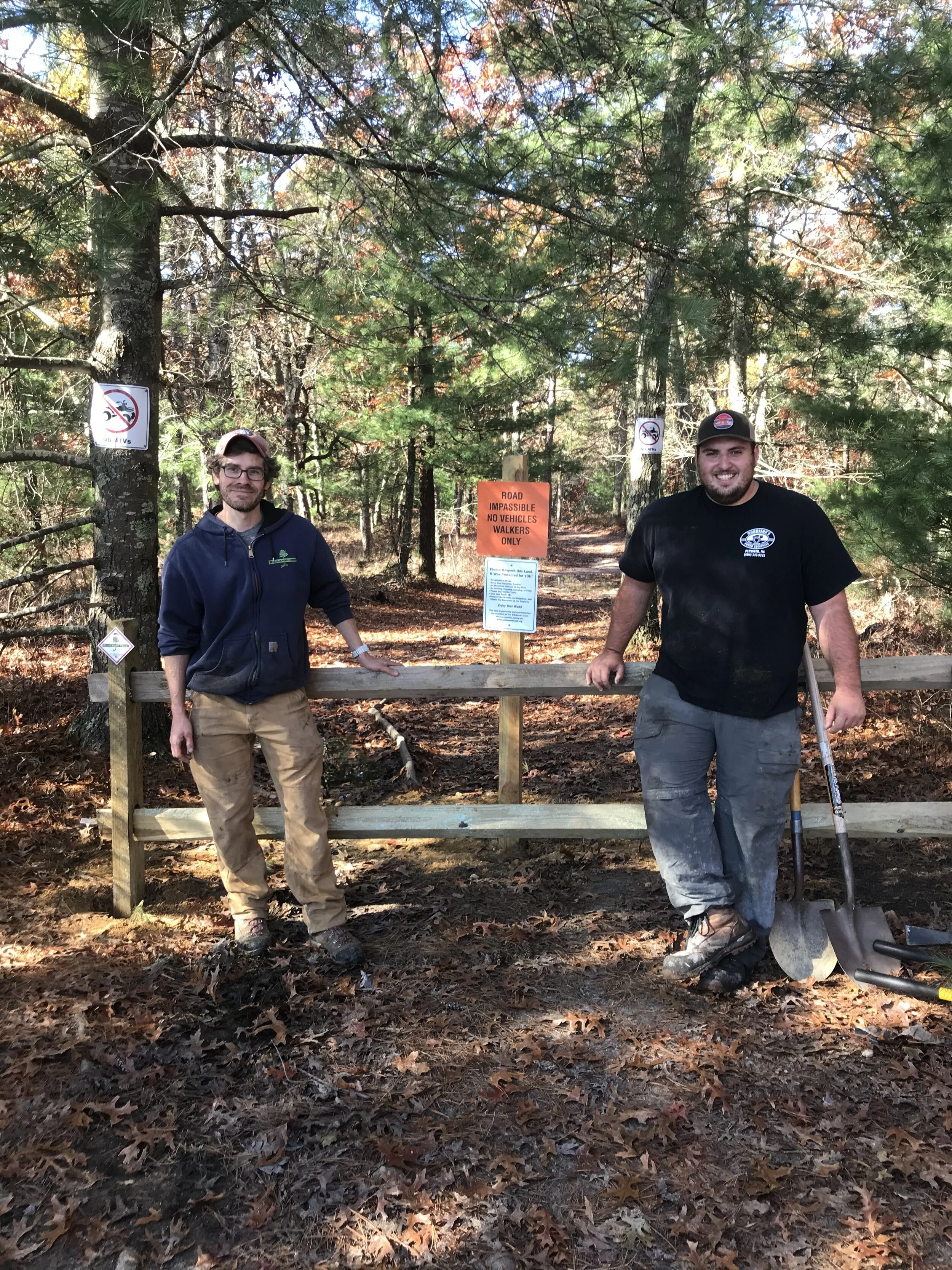 Stewardship Manager Erik Boyer (left) and Land Steward Owen Grey (right) at Muddy Pond Preserve after closing a main ATV entry point.