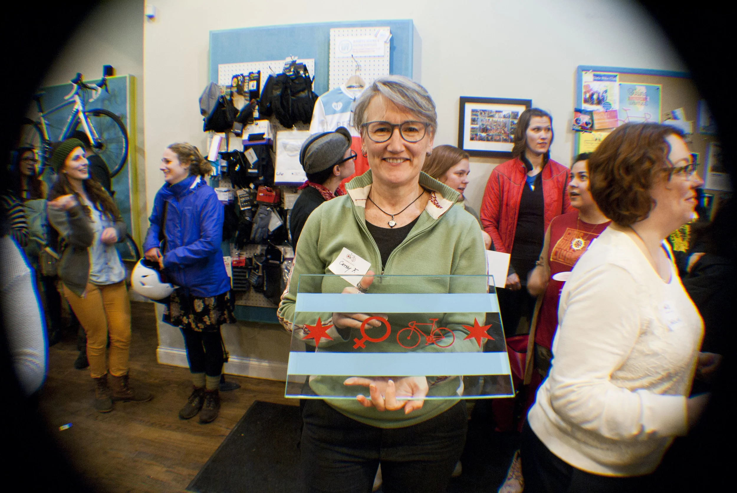 Our raffle winner of the custom Justin Haugen's Women Bike Chicago Glass art!