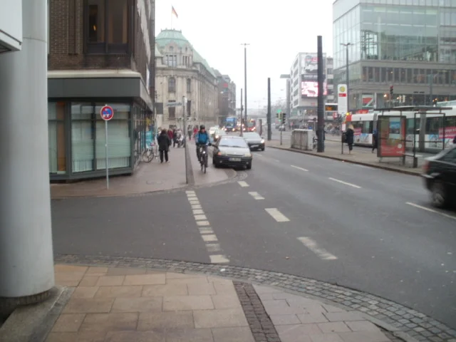 Car in the bike lane in Bremen. Sigh. An annoyed cyclist riding by.