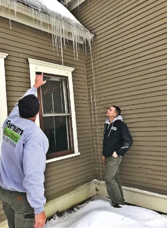 chad-farnum-of-farnum-insulators-talks-about-icicle-buildup-on-local-brattleboro-vt-home.jpg