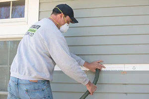 Chad blows insulation into the walls