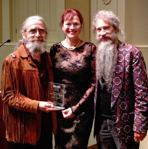 ISTA founder Mandala Cromwell presenting the award to Flournoy and Jose at their 10 Anniversary Conference.