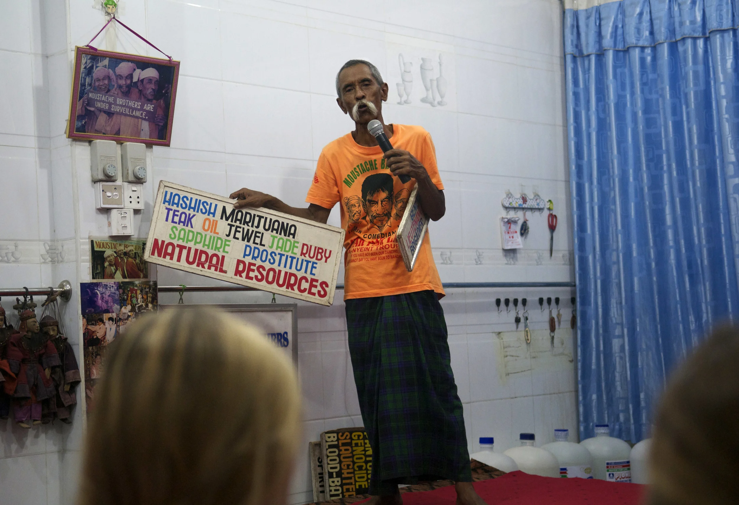 Lu Maw, one of the Moustache Brothers in Mandalay, entertains a crowd of foreigners during a show. (Credit: Dene-Hern Chen)