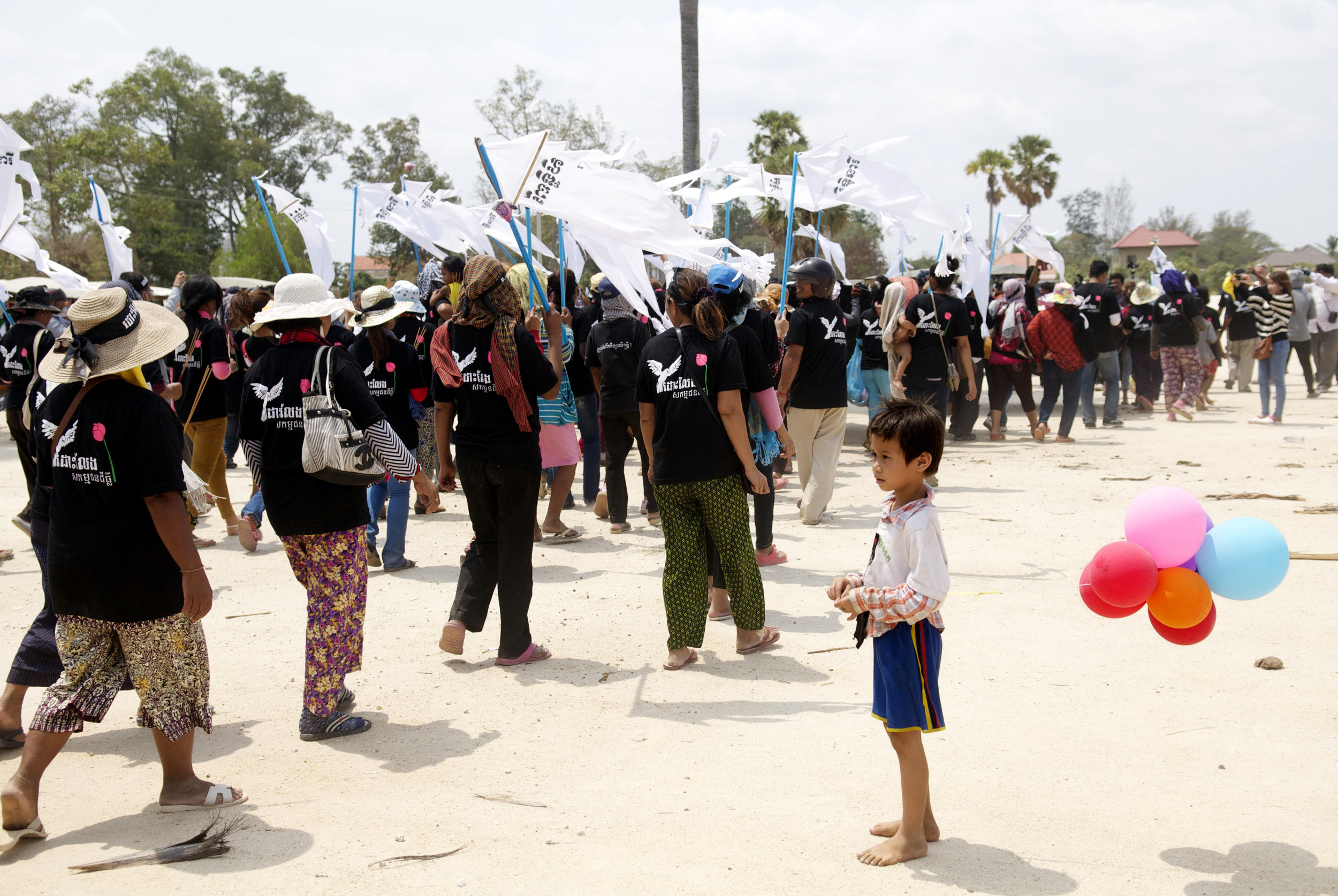 A young boy watches on as communities march to a local prison where activists have been jailed. (Credit: Dene-Hern Chen)