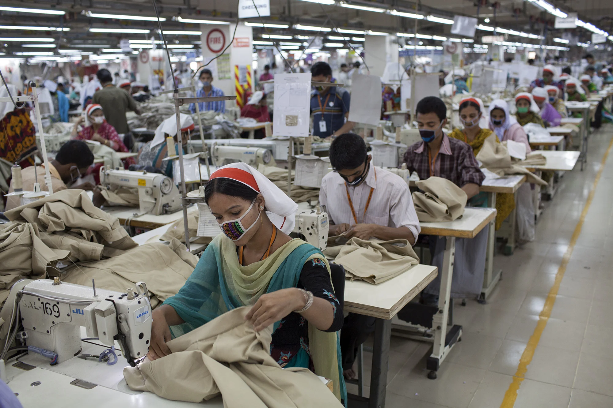 Garment workers on a sewing line at the Sparrow Apparels Limited garment factory in the Gazipur area of Dhaka, Bangladesh. (Credit: Will Baxter)