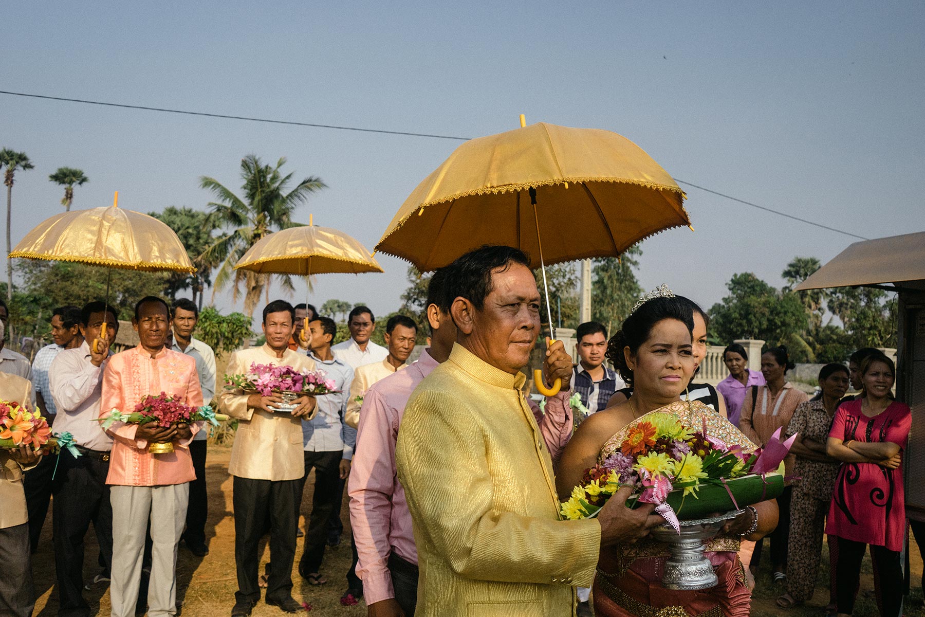 Yim Ran (right) and Sok Hort join in the fruit parade that traditionally accompanies a Cambodian wedding. 