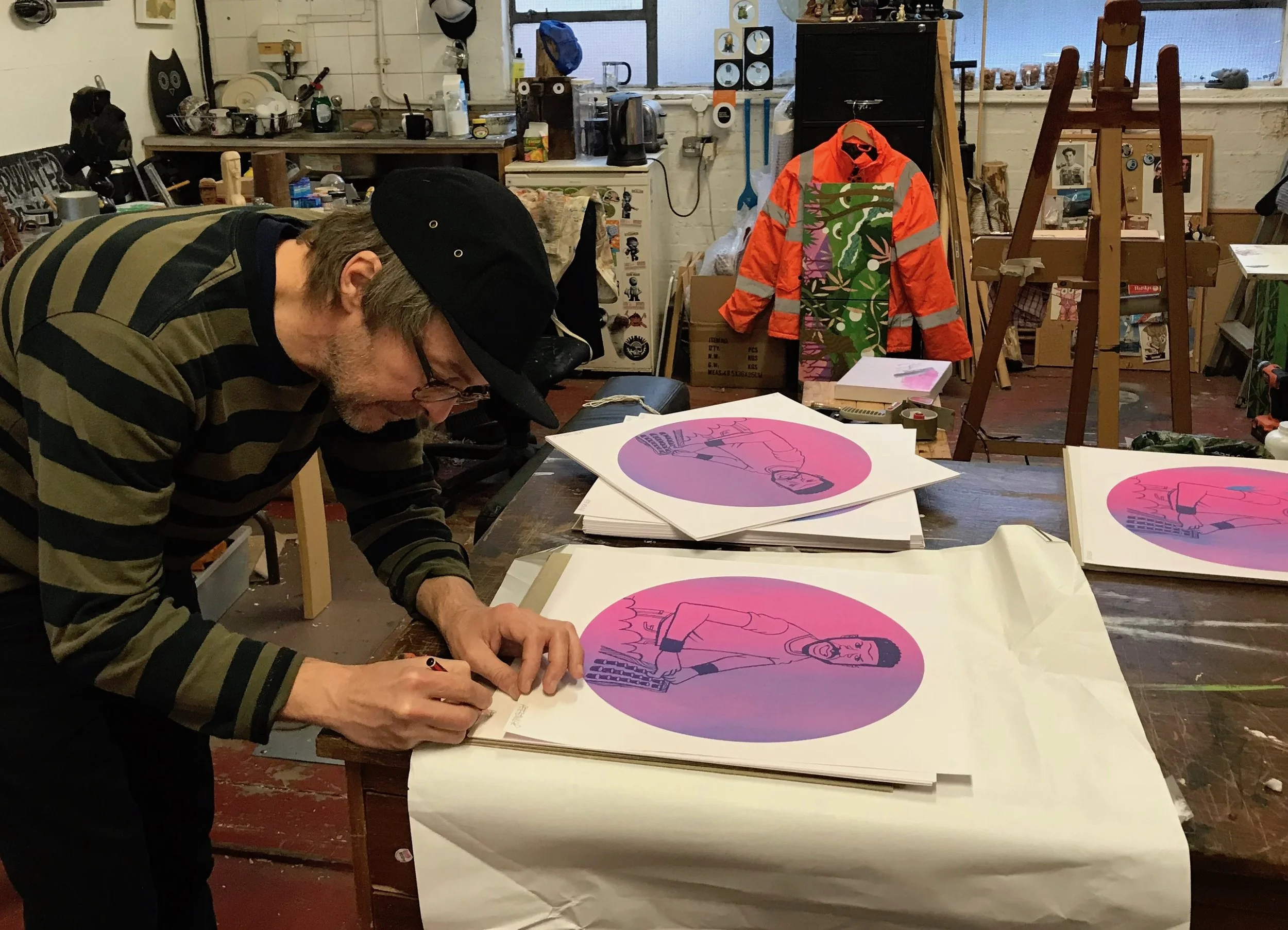 Pete signing the prints in his East London studio