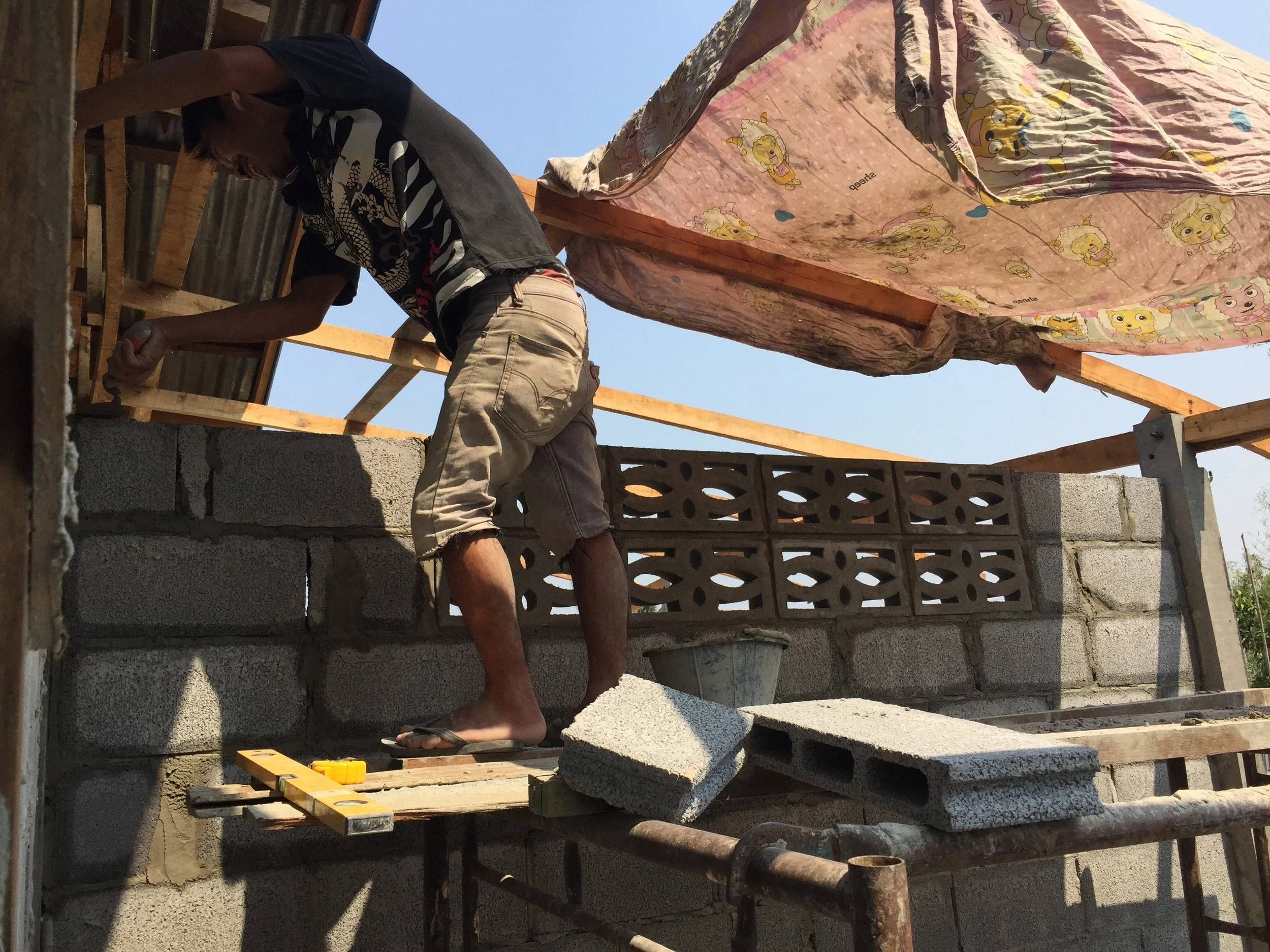 A neighbor helping out on the wall March, 2015 Ban Chiang Yuen, Thailand