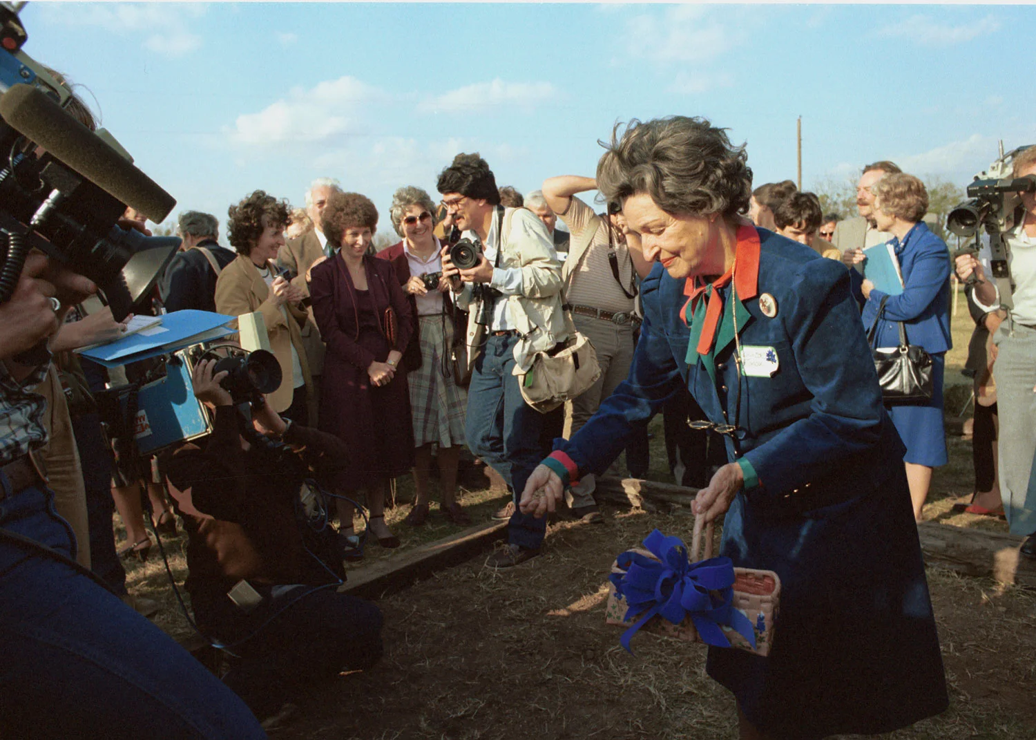 Lady Bird Johnson spreads seeds on the site of the National Wildflower Research Center. LBJ Library photo by Frank Wolfe.