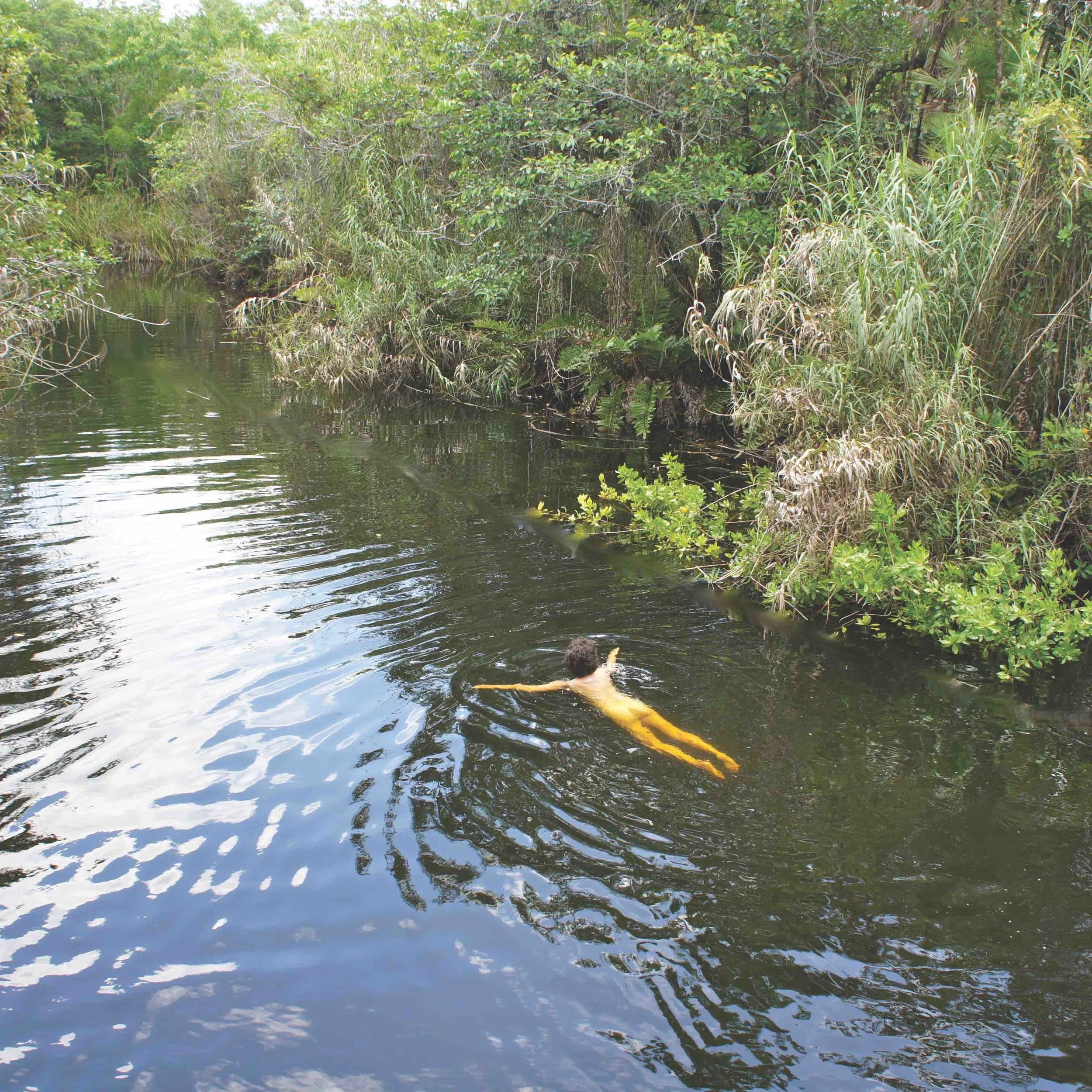 Bare-skinned breast-stroking through low hanging branches in a Mexican hideaway. Shot by Michael Chalmers.